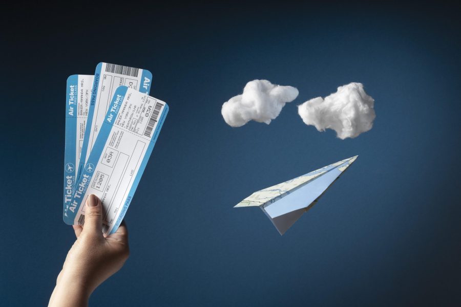 close-up-hand-holding-plane-tickets